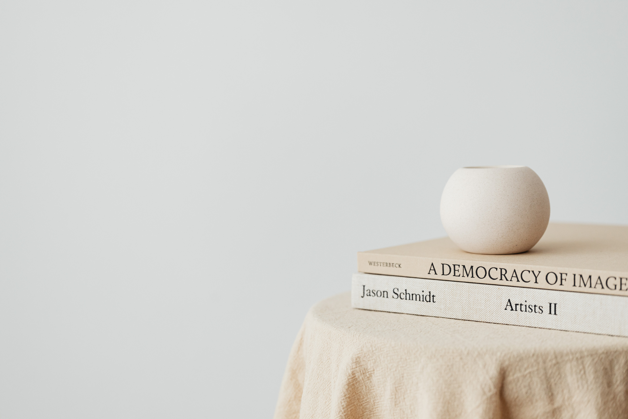 Books on a Table against a White Wall